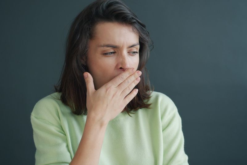 a woman covering her mouth